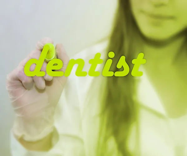 Woman writing Dentist word — Stock Photo, Image