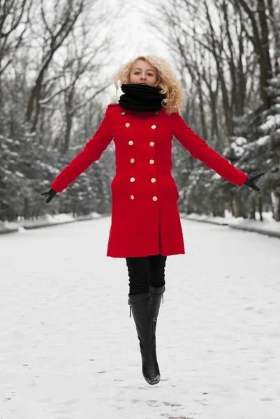 Pretty girl is jumping in snow — Stock Photo, Image