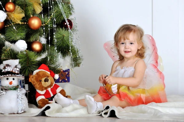 Little girl at a Christmas fir-tree — Stock Photo, Image