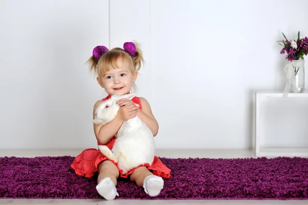 Smiling little girl and white rabbit Royalty Free Stock Photos