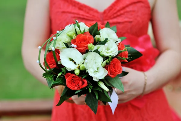 Noiva em vestido vermelho segurando buquê de casamento — Fotografia de Stock