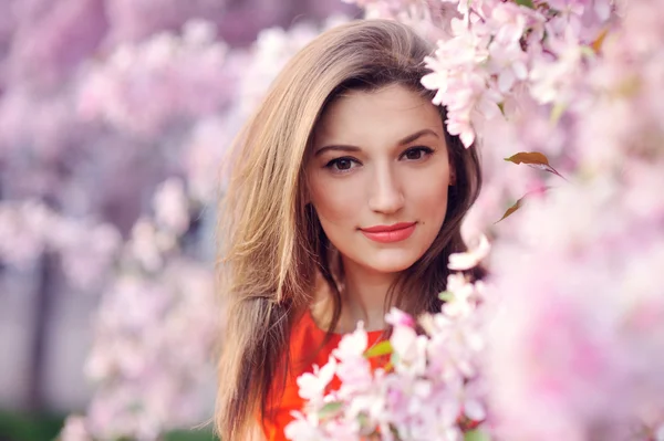 美丽的年轻女孩在公园和一棵开花的树 — 图库照片