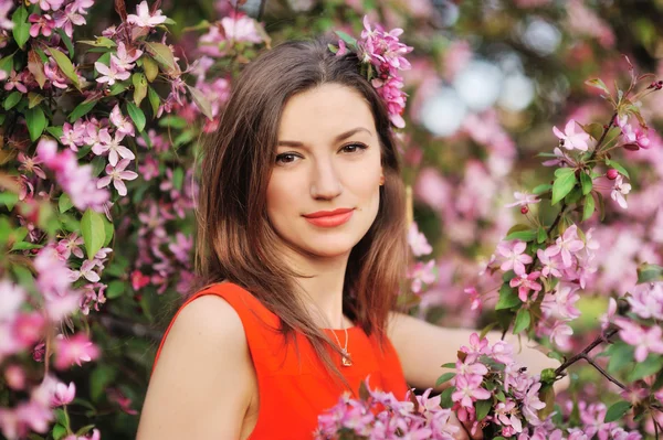 Piękna młoda kobieta w wiosenny ogród w pobliżu kwitnące drzewo — Zdjęcie stockowe