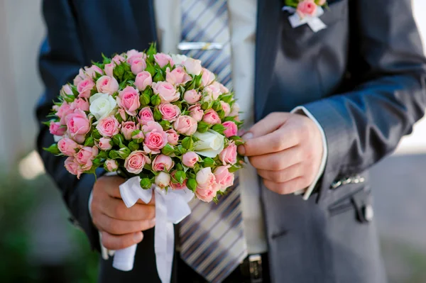 Marié tient un bouquet de mariage — Photo