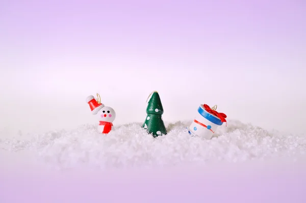 Speelgoed sneeuwpop boom en gift op sneeuw — Stockfoto