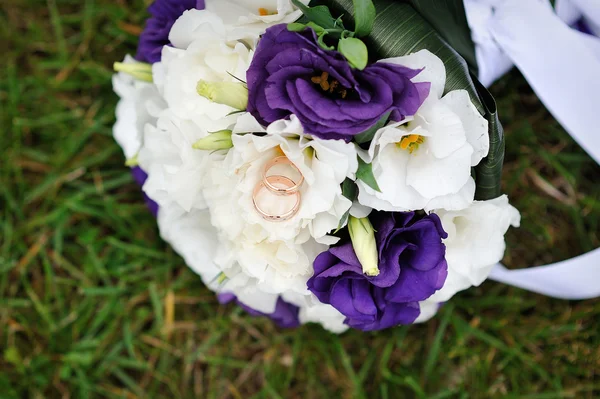 Buquê de noiva deitado na grama verde — Fotografia de Stock