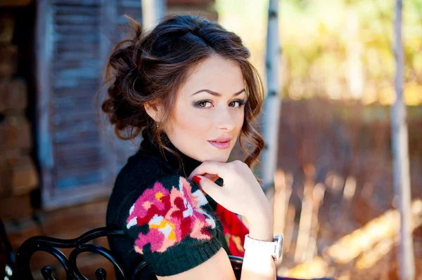 Portrait of a young woman near the wooden wall — Stock Photo, Image