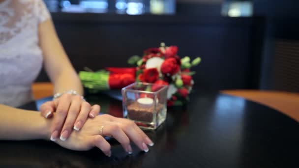 Bride with a wedding bouquet sitting in the cafe at the table — Stock Video