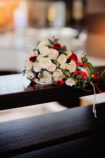 bridal bouquet of roses on a wood table