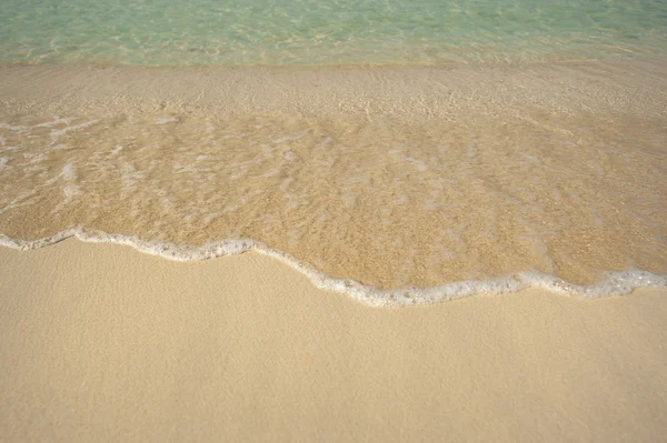Agua clara y arena en la orilla del mar — Foto de Stock