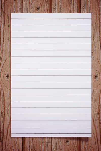 Livro branco sobre piso de madeira — Fotografia de Stock