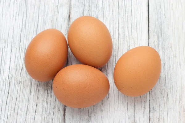 Eggs stack isolated on a wooden table — Stock Photo, Image