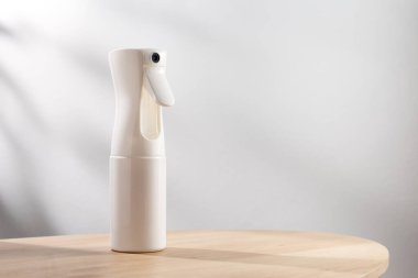 Alcohol spray bottle on a simple background