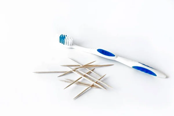 Günlük diş temizliği için diş ipi ve beyaz arka planda tahta bambu kürdan. Diş hekimliği. Diş fırçası. Yakın plan.