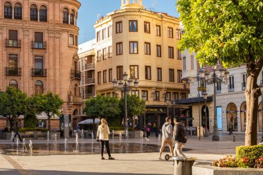 Cordoba, Endülüs, İspanya - 5 Kasım 2021: Günümüz Cordoba 'sındaki Plaza de las Tendillas manzarası, bir çeşme ve güzel yüzlü evler, güneşli bir günde insanlar yürür.