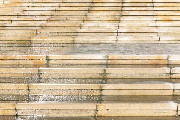 Wet stone stairs in the rainy day . White staircase in the park