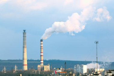 Şehirdeki endüstriyel borulardan duman çıkıyor. Endüstriyel kirliliğin zehirli dumanı