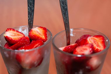 Chopped strawberry in the cup . Dessert with berries and sugar . Healthy fresh nutrition