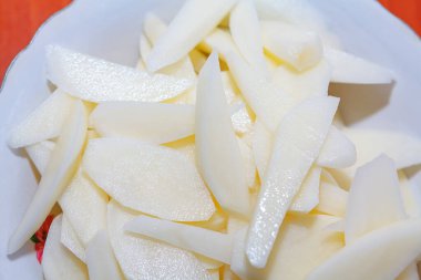 White chopped potatoes . Raw potato in the plate 