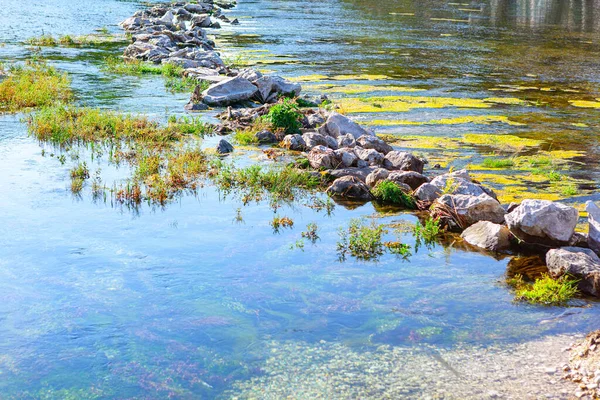 Flowing water over the stones in the river