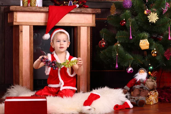 A boy with grapes on the New Year — Stock Photo, Image