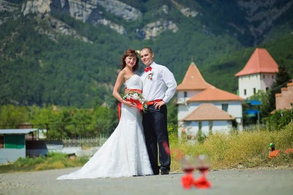 Bruid en bruidegom op de achtergrond van bergen — Stockfoto