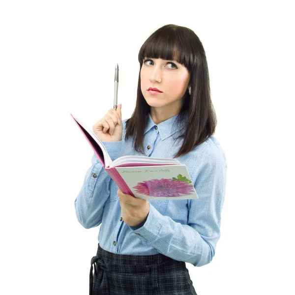 Ein nachdenkliches College-Mädchen mit Stift und Lehrbuch, isoliert auf wh — Stockfoto