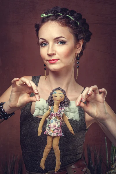 Portrait of a beautiful woman with a handmade doll — Stock Photo, Image