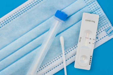 Coronavirus covid 19 için antijen testi yapın. Laboratuvar kartı koronası hızlı test cihazı. Olumsuz sonuç. Burun çubuğu, tüp ve maske takın. 