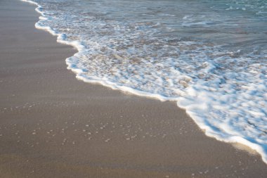 Deniz ya da okyanus manzarası. Güneşin altında deniz dalgaları. Yaz tatili ve seyahat konsepti. Su dalgası yüzeyi. Kumsal. 