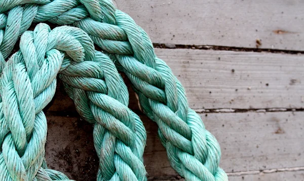 Wooden boards with green ship rope — Stock Photo, Image