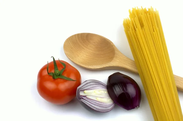 Spaghetti, tomato, red onion and wooden spoon — Stock Photo, Image