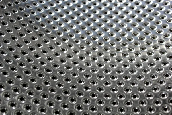 Perforated bright metal — Stock Photo, Image