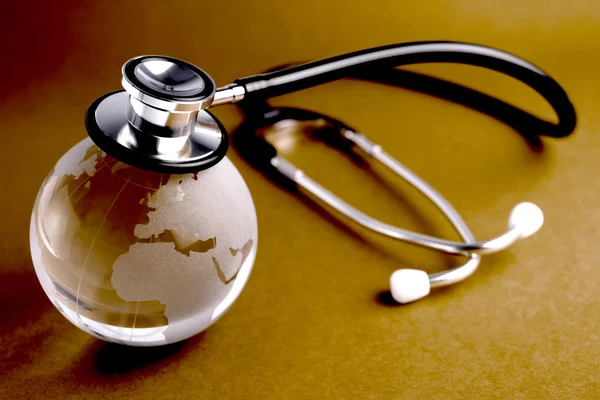 Stethoscope and crystal globe - — Stock Photo, Image