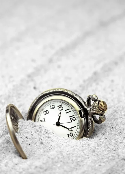 Antique pocket watch buried in sand. — Stock Photo, Image