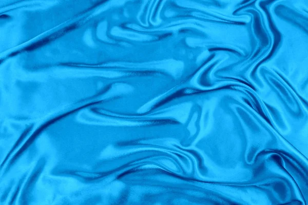 Синяя волнистая шелковая ткань — стоковое фото