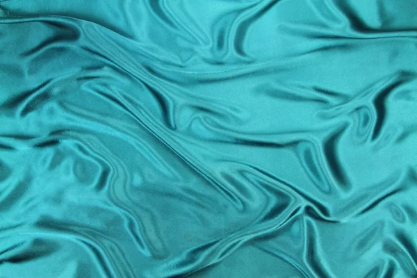 Turquoise wavy silk fabric — Stock Photo, Image