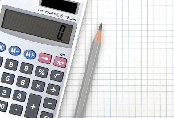 Calculator and lead pencil on squared paper — Stock Photo, Image