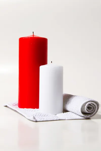 Ed and white candle on a white background — Stock Photo, Image