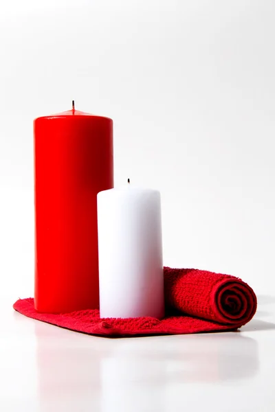 Ed and white candle on a white background — Stock Photo, Image