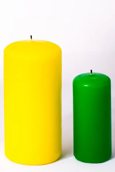 Green and yellow candle on a white background — Stock Photo, Image