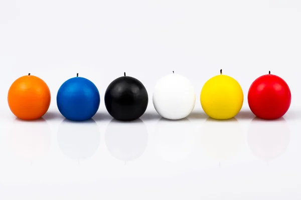 Six colored candles on a white background — Stock Photo, Image