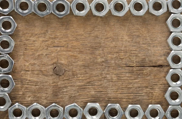 Herramienta de tuercas metálicas en madera —  Fotos de Stock