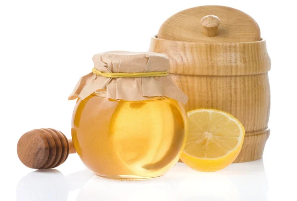 Frasco de mel e limão isolado em branco — Fotografia de Stock