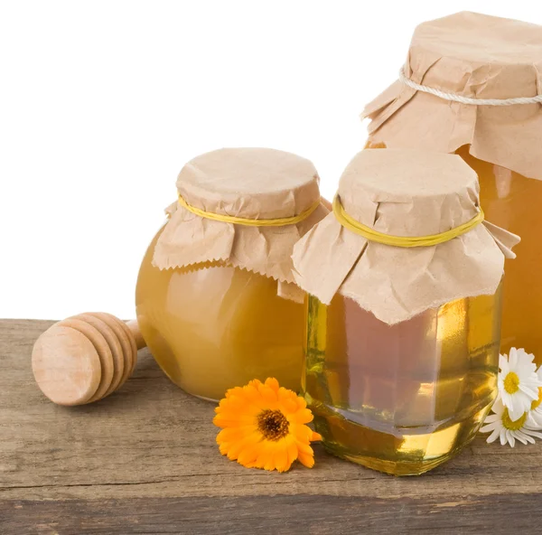 Honey in jar isolated on white background at old wood wood — Stock Photo, Image