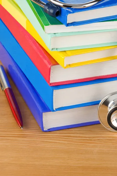 Medical stethoscope with pile of book — Stock Photo, Image