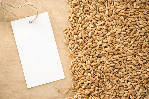 Wheat grain on wood texture — Stock Photo, Image