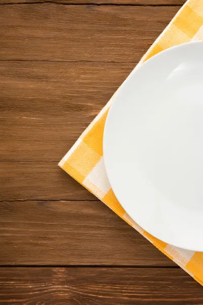 Plate at napkin on wood — Stock Photo, Image