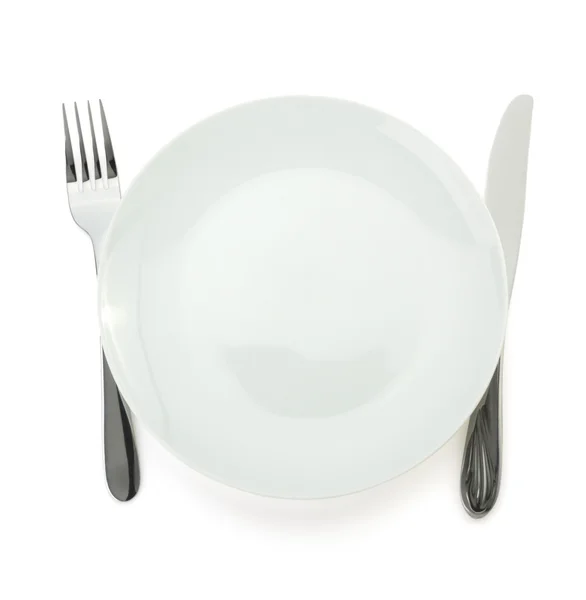 Plate, knife and fork on white — Stock Photo, Image