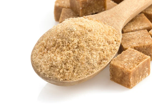 Brown sugar and spoon on white — Stock Photo, Image